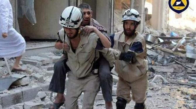 Sogenannte Weißhelme bringen in Aleppo einen evrletzten Mann in Sicherheit. Foto: Syria Civil Defence
