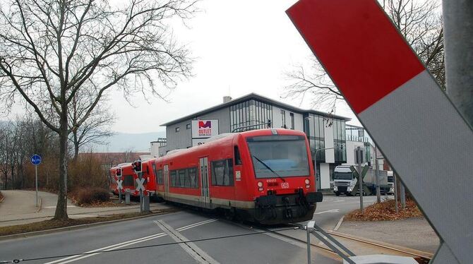Ein Zug der Ermstalbahn  befährt den  Bahnübergang auf der Noyon-Allee in Metzingen.