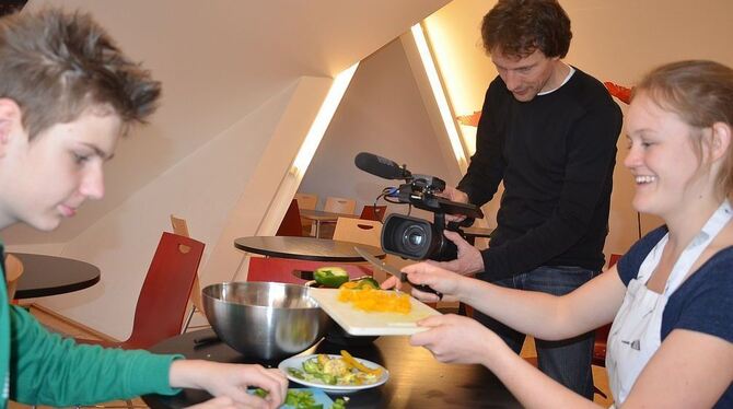 Der Achtklässler Pascal Mutsch zeigt mit FSJlerin Corinn Holder, was er bei der Essenszubereitung drauf hat. Beide sitzen vor de