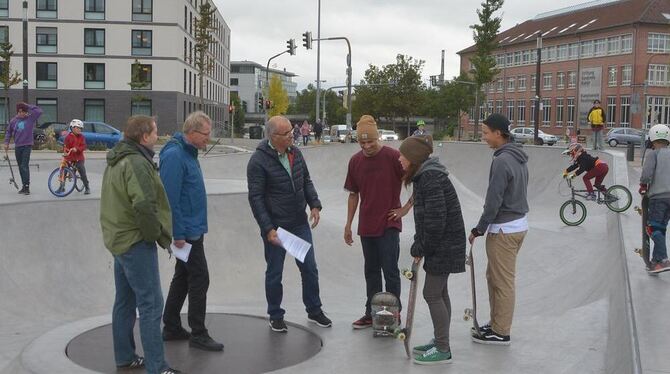 Die SPDler (von links)  Sebastian Weigle, Helmut Treutlein und Ramazan Selcuk im Austausch mit jungen Skateboardern.