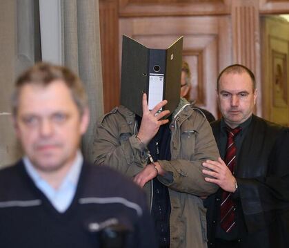 Verteidiger Andreas Eggstein (rechts) führt den jetzt wegen Mordes mit einem Messer verurteilten Mann in den Saal des Tübinger L