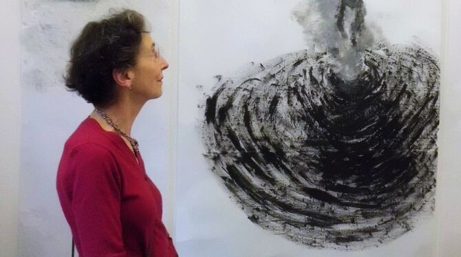 Kirsten von  Zech-Burkersroda vor ihrer Zeichnung auf Makulapapier (Ausschnitt), auf der Ubu von einem Schwarzen Loch verschlung