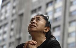 Eine Frau betet bei einer Messe für die Opfer des Erdbebens unter freiem Himmel in Mexiko-Stadt. Foto: Rebecca Blackwell
