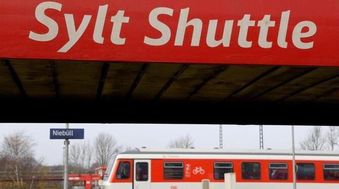 Ein Wagen des Autozuges »Sylt Shuttle« und ein Nahverkehrszug in Niebüll. Foto: Carsten Rehder