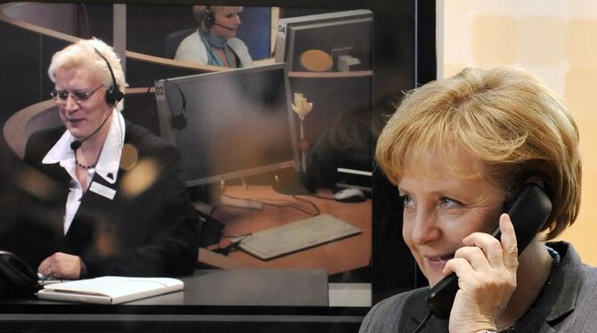 Bundeskanzlerin Angela Merkel telefoniert beim IT-Gipfel in Stuttgart mit der Behördennummer 115.