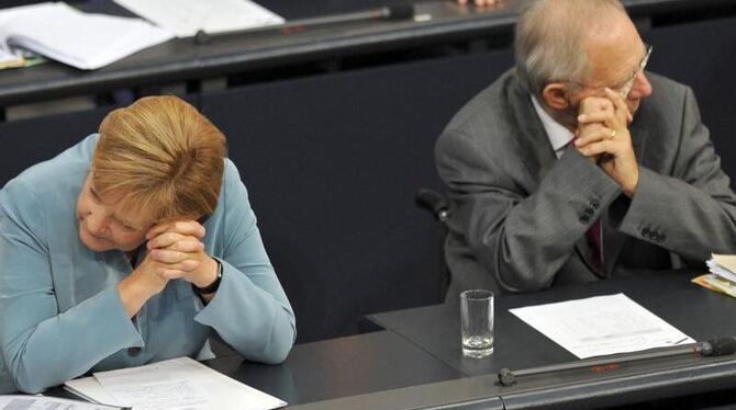 Bundeskanzlerin Angela Merkel und Bundesfinanzminister Wolfgang Schäuble (beide CDU) sitzen im Plenarsaal des Bundestages in