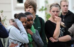 Jugendliche stehen am Montag in Lörrach vor dem Elisabethen-Krankenhaus und gedenken der Opfer des Amoklaufs. 