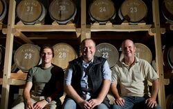 Immanuel Gruel (links), Hans-Peter Schwarz (Mitte) und Thomas Dannemann sitzen im Whiskey-Lager der Brennerei Gruel in Owen.