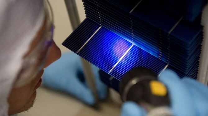 Ein Forscher betrachtet während eines Fototermins im Photovoltaik Technologie Evaluationscenter (PV-TEC) im Fraunhofer-Institut