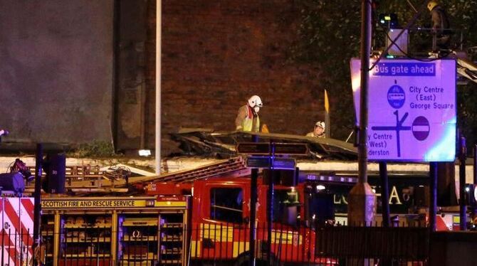 Feuerwehrmänner am Ort des Unglücks in Glasgow. Foto: Andrew Milligan