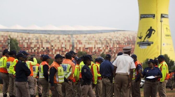 In Vorbereitung der Trauerfeier werden Polizisten vor dem FNB-Stadion eingewiesen. Foto: Ian Langsdon