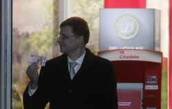 Lettlands Ministerpräsident Valdis Dombrovskis hob erstmal zehn Euro ab. Foto: Valda Kalnina