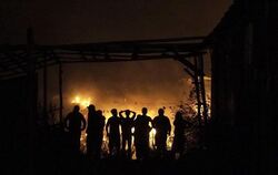 Fassungslos beobachten Anwohner und Schaulustige das Flammenmeer. Hunderte Gebäude wurden bereits zerstört. Foto: EPA