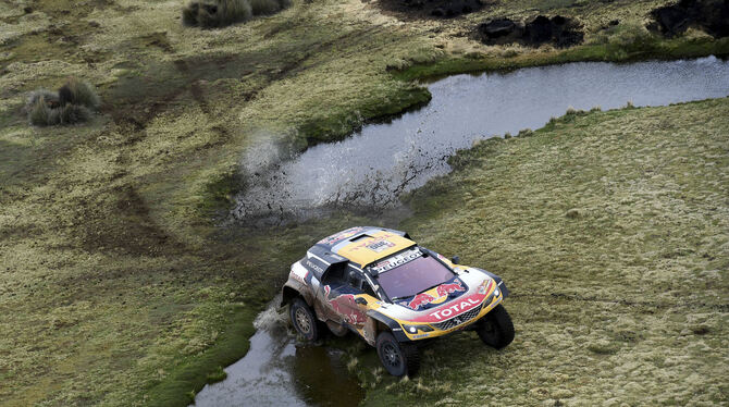 Erst Wüste, dann Wasser-Durchfahrten: Stephane Peterhansel im Peugeot. FOTO: DPA