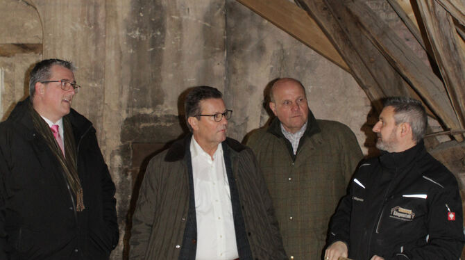 Minister Peter Hauk (2. von links) lässt sich von Zimmermann Jürgen Klingenstein (rechts) das Dach im Trochtelfinger Schloss zei