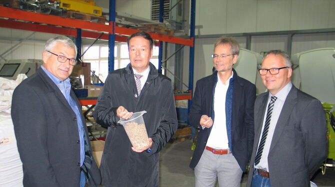 Unternehmer Harald Späth, von links, zeigt Regierungspräsident Klaus Tappeser die von ihm hergestellten Pellets. Architekt und S