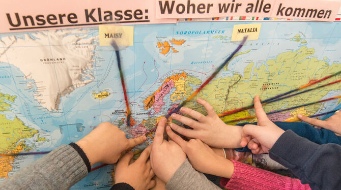 Ausländische Schüler zeigen auf einer Karte an, woher sie kommen.