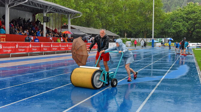 Alle halfen mit, die blaue Tübinger Bahn von den Wassermassen zu befreien – vergeblich. FOTO: PACHER Alle halfen mit, die blaue Tübinger Bahn von den Wassermassen zu befreien – vergeblich. FOTO: PACHER