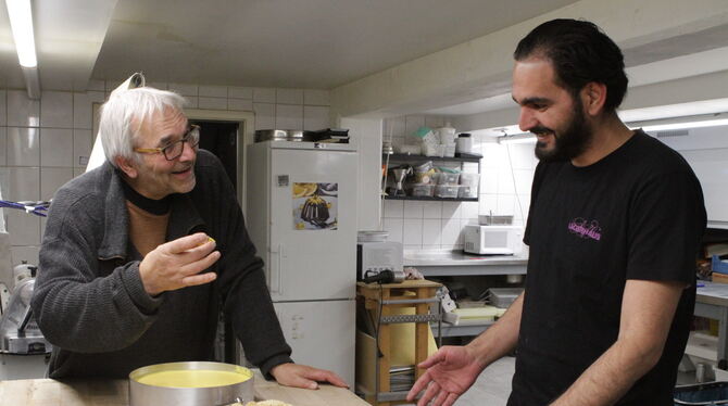 Lagerhaus-Chef Eberhard Laepple kostet Fadi Abozeeds syrisches Sesamgebäck.  FOTO: SCHRADE