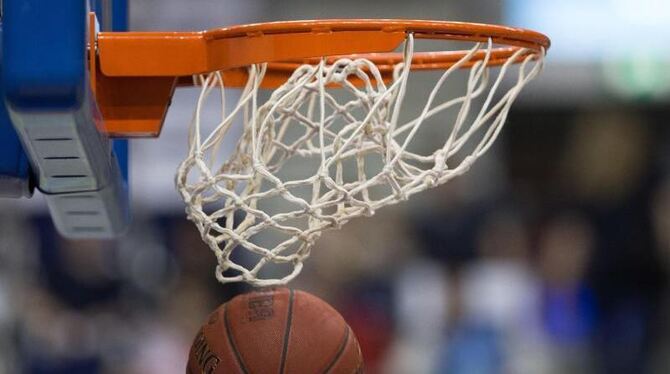 Ein Basketball fällt durch das Netz vom Basketballkorb
