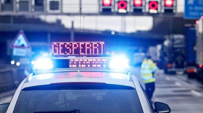 Auf einem Polizeifahrzeug leuchtet die Aufschrift »Gesperrt«
