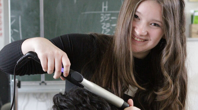 Sara Bednaic macht ihren Mitschüler Sepanta Yousefi zum Lockenkopf.  FOTOS: SCHRADE