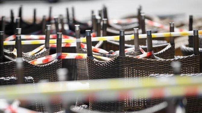 Gestapelte Stühle vor einem Restaurant sind abgesperrt