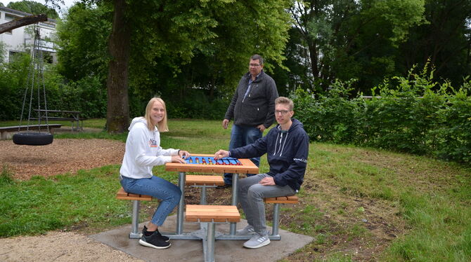 Julia Jestädt und Michael Schwarz vom Jugendgemeinderat mit Bauhofleiter Bernd Pudelko (Mitte) am neuen Spieltisch auf dem Spiel