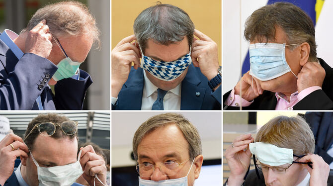 Aller Anfang ist schwer. Politiker beim Aufsetzen des Mund-Nasen-Schutzes.  FOTOS: DPA