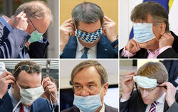 Aller Anfang ist schwer. Politiker beim Aufsetzen des Mund-Nasen-Schutzes.  FOTOS: DPA