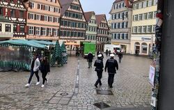 Zwei Polizisten laufen über den Tübinger Marktplatz.