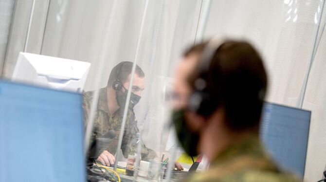 Soldaten telefonieren in einem Raum des Gesundheitsamtes