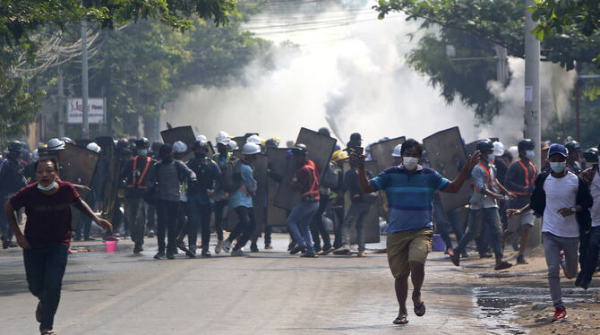 Das Militär setzt Tränengas bei Protestmärschen in der Millionenmetropole Myanmar ein. FOTOS: DPA