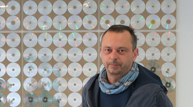 Steffen Schlichter vor seinem Werk »Spex« aus CDs und CD-Hüllen aus dem gleichnamigen Musikmagazin.  FOTO: KNAUER