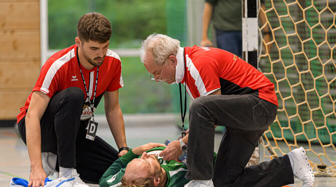 VfL-Torhüter Simon Tölke wird von Physiotherapeut Moritz Eitel (links) und Mannschaftsarzt Dr. Ulrich Dobler behandelt. FOTO: WO
