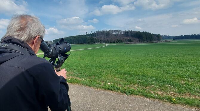 Diplom-Biologe Matthias Klemm hält aus großem Abstand Ausschau nach dem Rotmilan. In dem Wald am Horizont haben seine Mitarbeite
