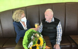 Ein Gläschen auf die Gesundheit: Baubürgermeisterin Angela Weiskopf brachte Jubilar Heinz Parthum einen Blumenstrauß mit.  FOTO: