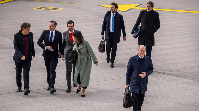 Olaf Scholz und seine Minister von Grünen und FDP haben sich vertagt und laufen zum Flugzeug nach Holland.  FOTO: KAPPELER/DPA