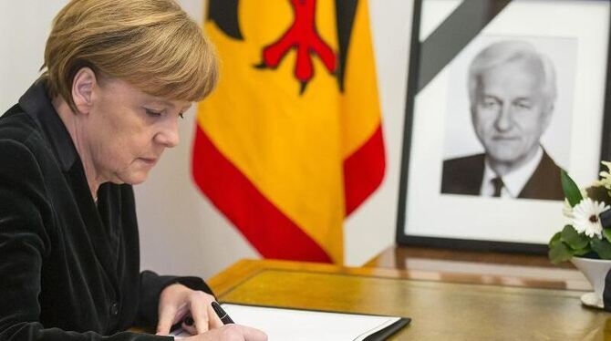 Angela Merkel trägt sich in Berlin ins Kondolenzbuch für von Weizsäcker ein. Foto: Hannibal Hanschke
