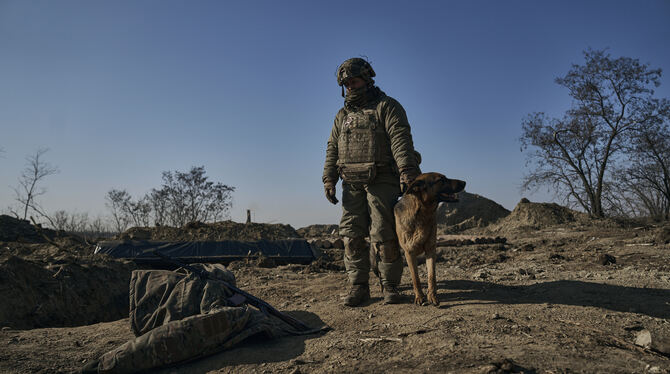 Ukraine, Bachmut: Ein Soldat der ukrainischen 3. Armee-Sturmbrigade der Special Operations Forces (SSO) »Asow« steht an einem Gr