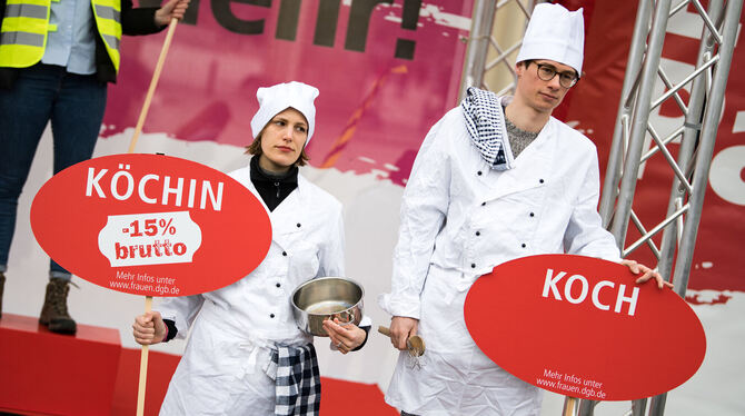 Berufspaare zeigen bei einer Gewerkschaftskundgebung in Berlin die Lohnunterschiede zwischen Mann und Frau auf.  FOTO: DPA