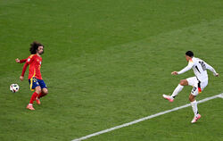 Spaniens Marc Cucurella (links) bekommt den Schuss von Jamal Musiala an die linke Hand.