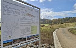 Ein Hinweisschild informiert über Funktion und technische Daten des Hochwasserrückhaltebeckens.