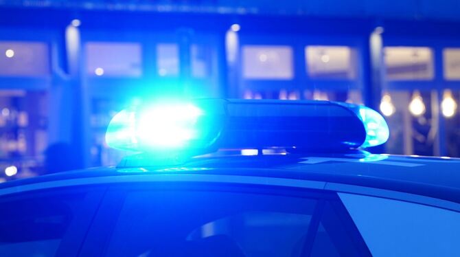 Ein Streifenwagen der Polizei mit eingeschaltetem Blaulicht Ein Streifenwagen der Polizei mit eingeschaltetem Blaulicht