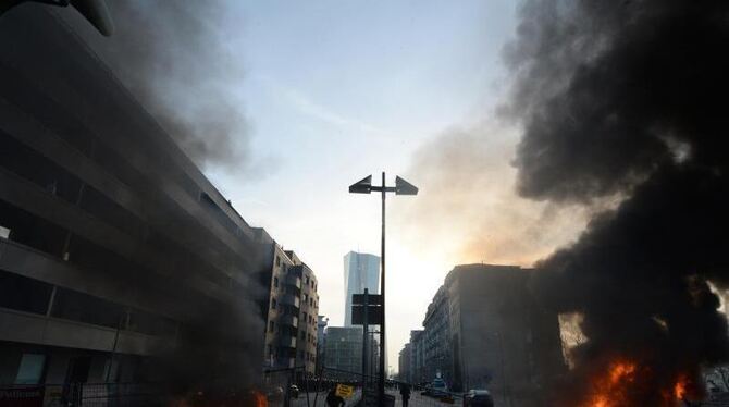Am Tag der offiziellen Eröffnung der EZB (hinten) brennen in der Frankfurter Innenstadt Barrikaden und Autos. Foto: Boris Roe