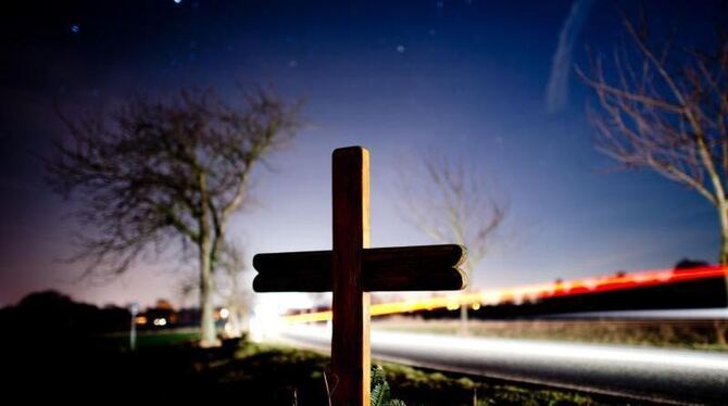 Ein Kreuz erinnert an einer Landstrasse an einen Verkehrstoten. Foto: Julian Stratenschulte/Illustration