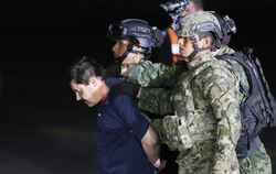"El Chapo" wird von Bewaffneten zu einem Armeehubschrauber gebracht. Foto: Jose Mendez
