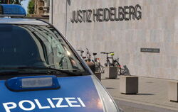 Ein Polizeiauto steht vor dem Heidelberger Landgericht.
